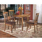 Ashley Furniture dining room chairs with wooden frame and cushioned seats around a round dining table