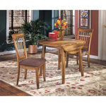 Ashley 2-4 person round kitchen table in wood finish with two matching chairs and decorative items